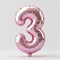 A pink balloon shaped like the number 3