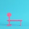 Pink barbell with bench on bright blue background in pastel colors. Minimalism concept