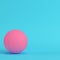 Pink basketball ball on bright blue background in pastel colors. Minimalism concept