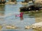 a pink beach chair sits in the water in the middle of a rocky lagoon. Paralimni. Ayia Napa. Cyprus