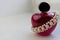 Pink beautiful glass transparent bottle of female perfume decorated with white precious pearls and place for a simple text