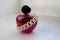 Pink beautiful glass transparent bottle of female perfume decorated with white precious pearls and place for a simple text