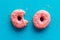 Pink berry donuts flat lay, top view. Glazed and sprinkles doughnuts