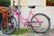 Pink bicycle Bikes available for rental, parked in the city center