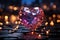 A pink big diamond heart shining standing on a pavement. Blurred candles and bokeh lights on a dark base in the