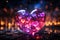 A pink big glass heart with little hearts inside if it standing on wet pavement. Blurred fire and bokeh lights on a dark