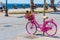 Pink bike in Alghero seafront promenade