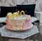 Pink birthday cake. Dessert for March 8th. Cake with decoration of butterflies and pearls. Close-up shot of the cake. Ideas for