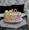 Pink birthday cake. Dessert for March 8th. Cake with decoration of butterflies and pearls. Close-up shot of the cake. Ideas for