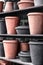Pink and black clay flowerpots on a shelf