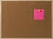 Pink Blank sticky notes yellow pinned into brown corkboard.