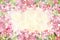 Pink blossom blooming flower border and frame on wooden background