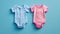 Pink and blue baby bodysuits on a blue top view. Gender reveal concept. Boy or girl