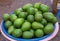 Pink and blue basket with pile fresh avocados