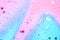 Pink and blue confetti and stars and sparkles on pink background