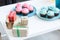 pink and blue cupcakes and gift boxes on white table, baby-party concept