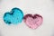 Pink and blue decorated fabric hearts laying in snow