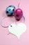 Pink and blue polka dot Easter eggs with white heart gift tag - vertical close-up