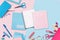 Pink and blue stationery items around of image.