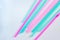 Pink and blue straws for coctails and other long drinks on white background