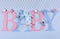 Pink and blue theme Baby bunting letters hanging from pegs on a line
