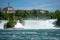 Pink boat float at rock observation on flowing river under the Rhein fall for background