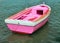 Pink boat in the middle of the ocean