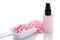 Pink body lotion in dispenser and aroma salt isolated