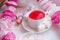 Pink breakfast of kawaii japanese girl - scented herbal tea in white cup, candy pink decor, marsmallow sweets, pretty morning tea
