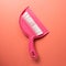 Pink broom and dustpan isolated on pink background