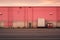 a pink building with a truck parked in front of it