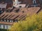 Pink buildings with brown rooftops, chimneys and windows