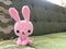 Pink bunny crochet doll in soft focus.