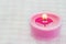 Pink burning candle on a romantic soft background