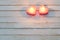 Pink burning candles on  wooden background