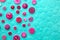 Pink buttons on turquoise background