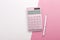 Pink calculator with pen background