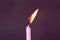 Pink candle light burn against black background