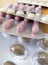 Pink capsules and beige tablets in blisters lie on a white table