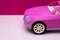 Pink car on a pink background. Concept of car sale, car rental or car rental.