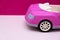 Pink car on a pink background. Concept of car sale, car rental or car rental.