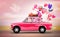 Pink car with symbols of love, holiday, happyness