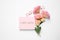 Pink card with phrase I Am Sorry and Eustoma flowers on white background, flat lay