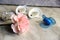 Pink carnation flower and four older pacifiers in sunlight. infant accessories