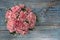 Pink carnation flowers bucket on blue wooden background
