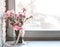 Pink carnations on white windowsill