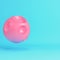 Pink cartoon styled moon with craters on bright blue background in pastel colors