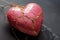 Pink ceramic heart with golden cracks on gray background. Generative AI