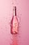 Pink champagne bottle on pastel background. Party background with sparkling wine, bubbling rose champagne, celebration concept.