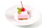 Pink cheesecake with maraschino cherry and mint